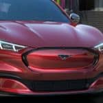 A close up of a red 2021 Ford Mach-E's grille is shown.