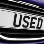 Used is shown on a blue car's license plate.