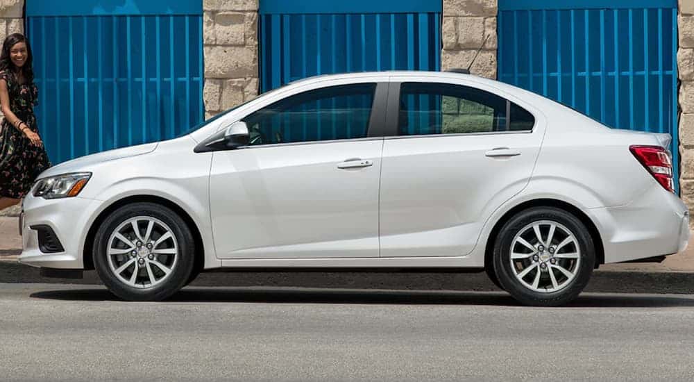A side view of a white 2020 Chevy Sonic is shown.