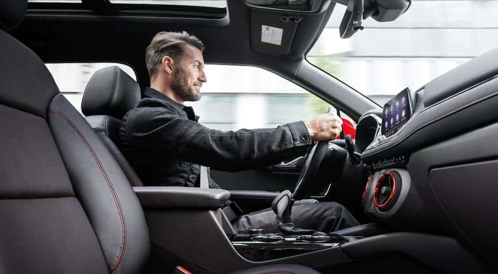 A man driving a 2020 Chevy Blazer is shown from an interior view.