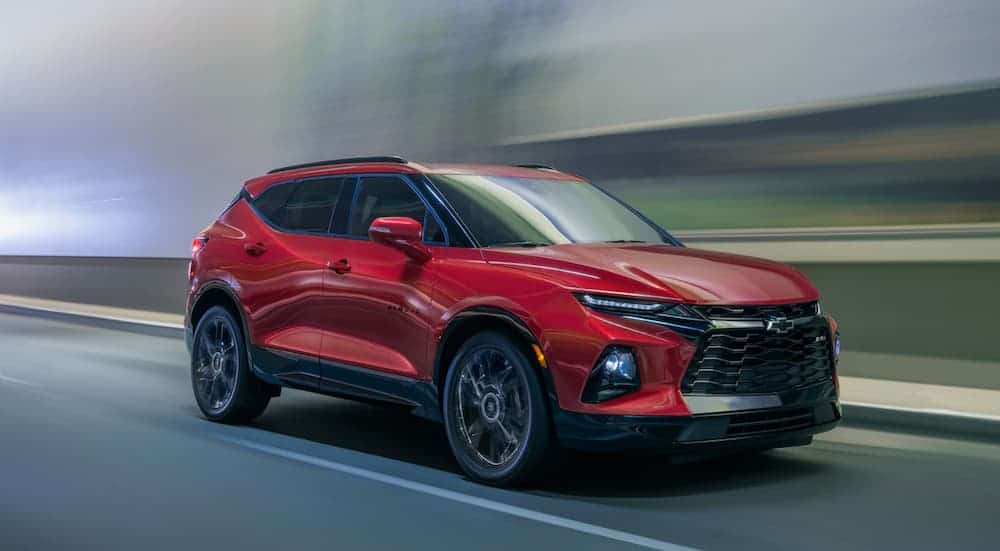A red 2020 Chevy Blazer is driving in a blurred tunnel.