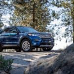 A blue Explorer is parked in the woods victoriously after winning 2020 Ford Explorer vs 2020 Toyota Highlander.