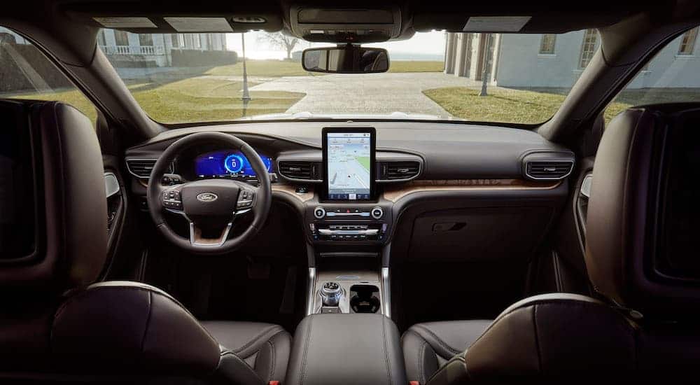 The front black leather interior of a 2020 Ford Explorer is shown. 
