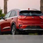 A red 2020 Kia Niro is facing away in a parking lot.