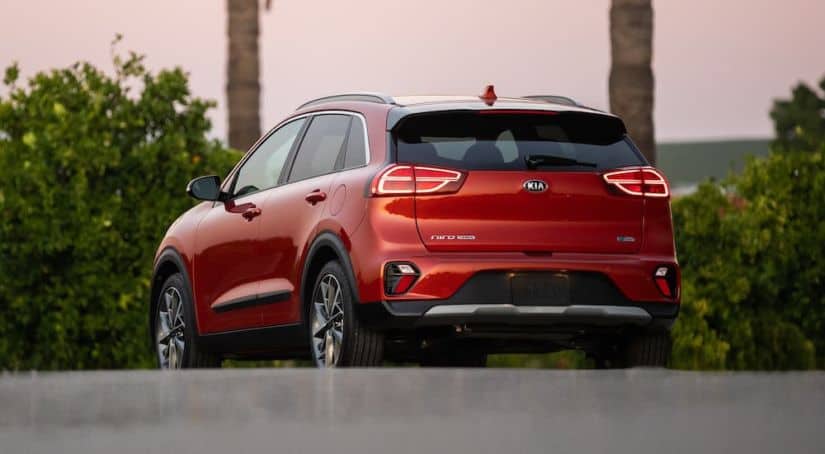 A red 2020 Kia Niro is facing away in a parking lot.
