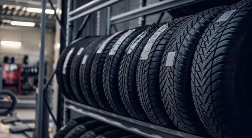 A row of tires are shown at a tire shop.