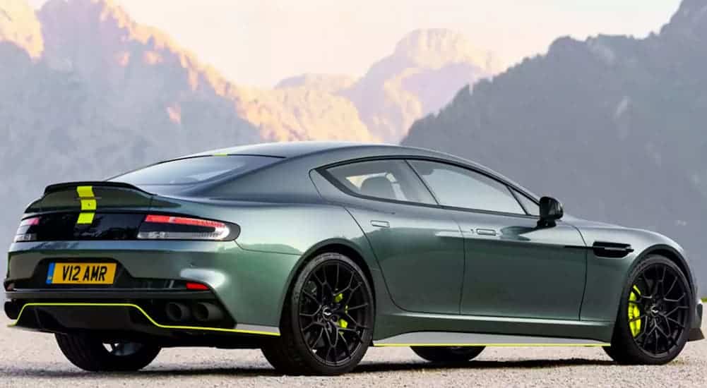 A green 2020 Aston Martin Rapide AMR is shown from the rear in front of mountains.