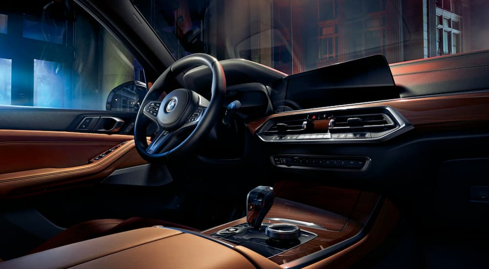 The black and brown interior of a 2020 BMW X5 is shown at night.