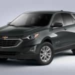 A dark grey 2020 Chevy Equinox LT is shown on a grey background.