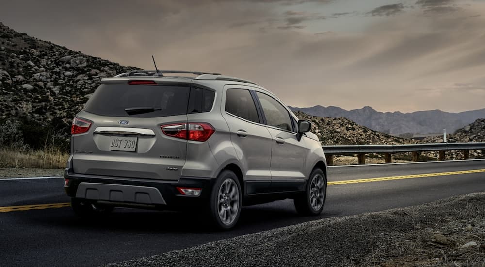 A silver 2020 Ford Ecosport, which wins when comparing the 2020 Ford EcoSport vs 2020 Jeep Renegade, is parked with mountain views.