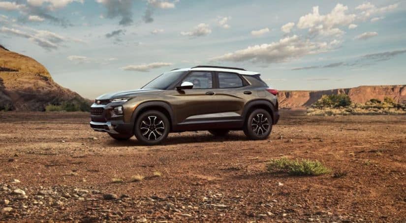 A brown and white 2021 Chevy Trailblazer Activ is parked victoriously in a desert after winning 2021 Chevy TrailBlazer vs 2020 Mazda CX-30.