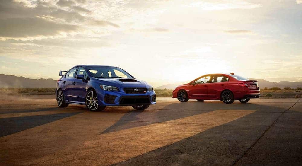The 2021 Subaru WRX will be redesigned from the red and blue 2020s shown here at sunset.
