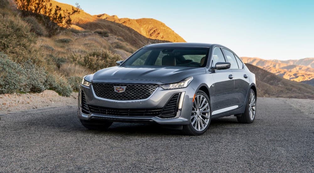 A gray 2020 Cadillac CT5 is parked on a road in a desert.