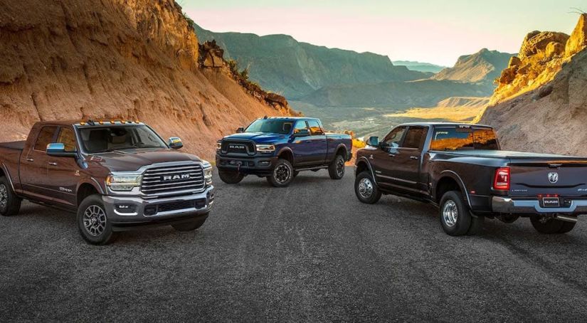 3 Ram Trucks, all 2020 Ram 2500s, are parked on a street in front of mountains.