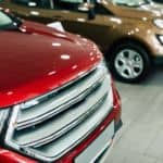 A selection of used SUVs for sale are shown in a showroom.