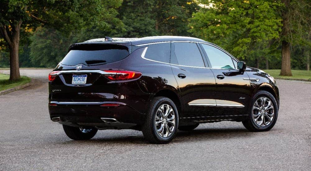 A black 2020 Buick Enclave Avenir is parked in an empty lot after winning 2020 Buick Enclave vs 2020 Kia Sorento.