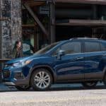 Two women are walking toward a blue 2020 CHevy Trax, parked on a city street after winning the 2020 Chevy Trax vs 2020 Nissan Kicks comparison.