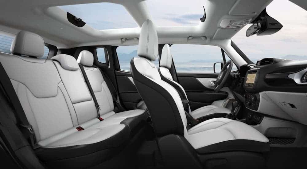 A side view is shown of the available white and black McKinley interior of a 2020 Jeep Renegade.