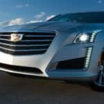 A silver 2017 used Cadillac CTS is shown against a blue sky.