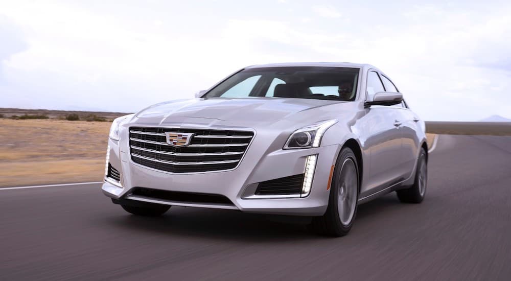 A silver 2017 used Cadillac CTS is driving on a race track.