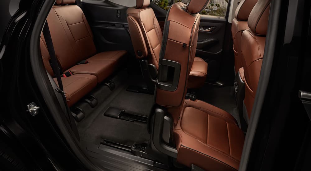 The brown interior of a 2020 Chevy Traverse is shown featuring the rear seating.