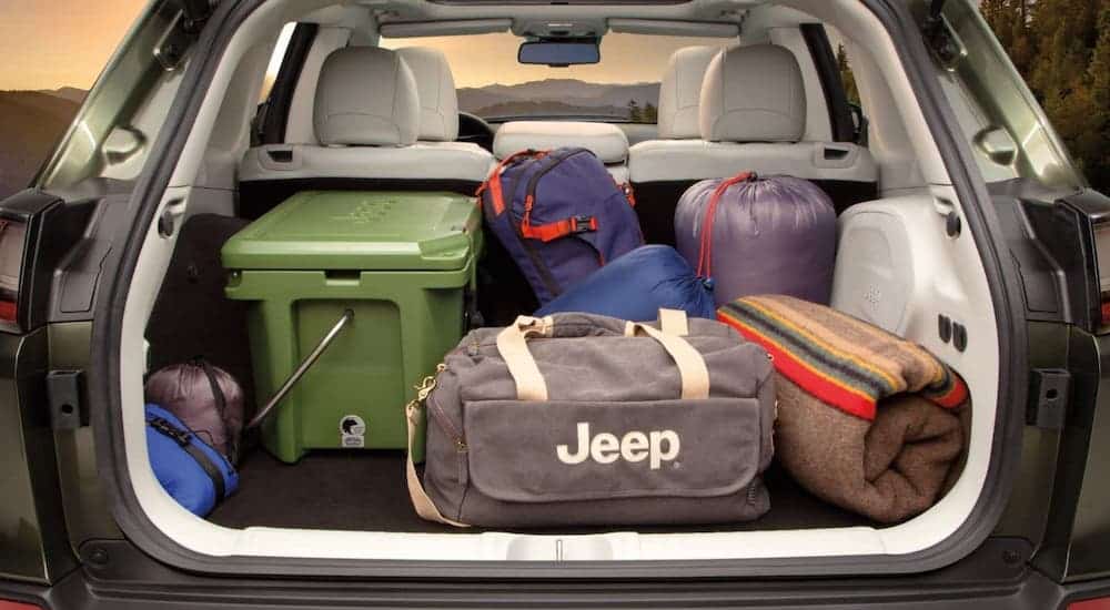 The cargo area of a 2020 Jeep Cherokee is shown full of luggage.