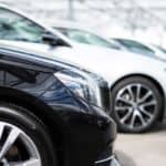 Black, white, and grey Certified Pre-Owned cars are in a line.