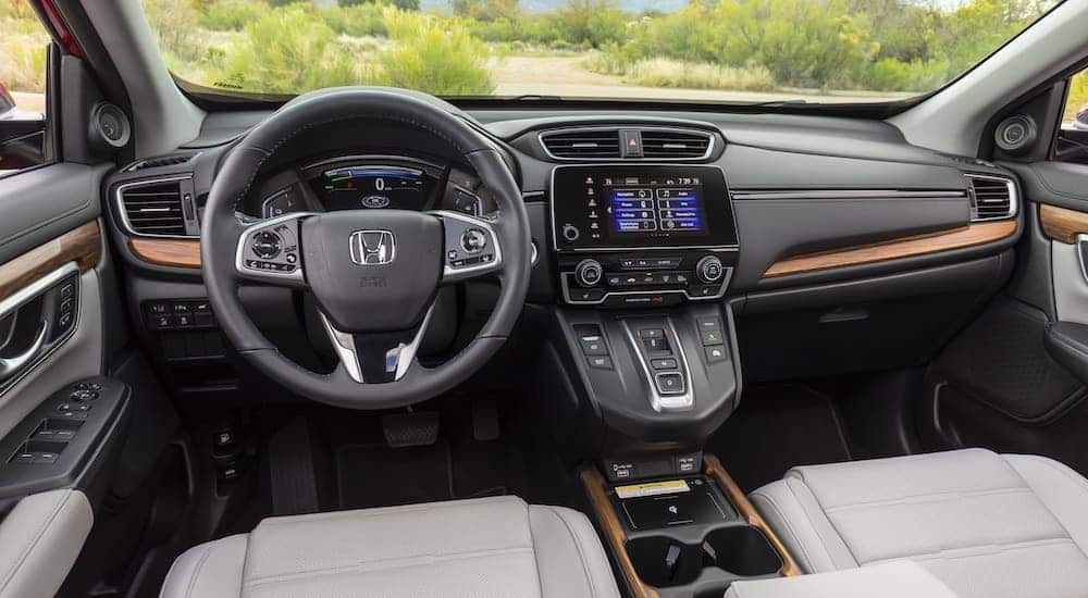 The gray dashboard and interior of a 2020 Honda CR-V Hybrid is shown.