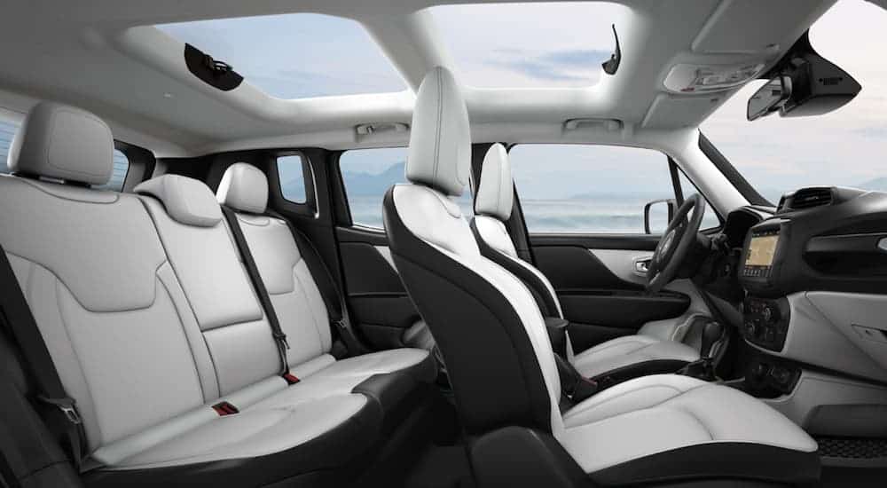 The white and black interior of the 2020 Jeep Renegade is shown from the side. 