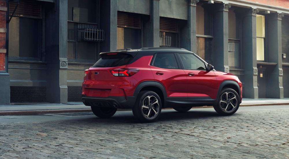 A red 2021 Chevy Trailblazer RS is parked on a cobblestone street.
