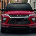 A red 2021 Chevy Trailblazer is shown from the front on a city street.