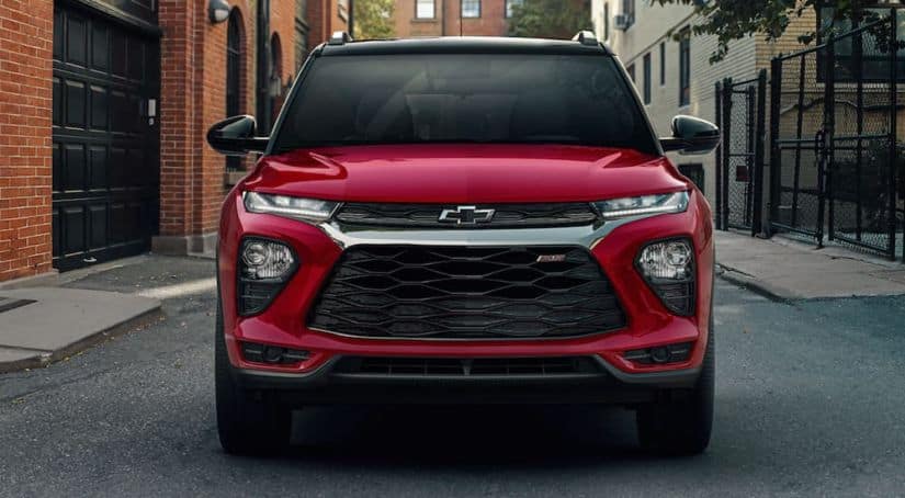 A red 2021 Chevy Trailblazer is shown from the front on a city street.
