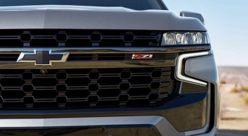 The grille of a grey 2021 Chevy Suburban is shown.