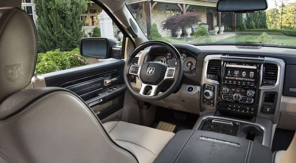 The black and beige interior of a 2018 Ram 1500 is shown.
