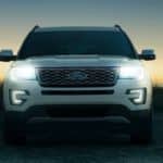 The front of a white 2017 Ford Explorer is shown from the front at sunset.