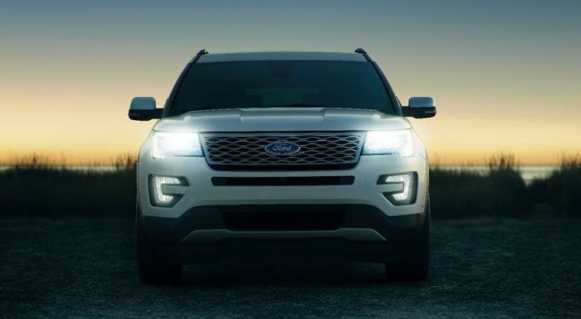 The front of a white 2017 Ford Explorer is shown from the front at sunset.