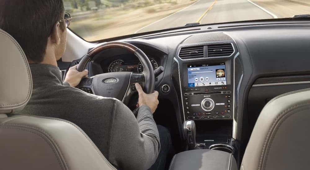 The interior of a 2017 used Ford Explorer is shown with a man driving.