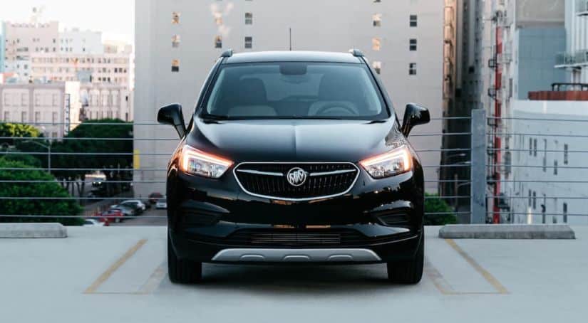 A black 2020 Buick Encore is shown from the front on a rooftop parking garage.