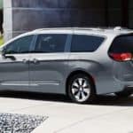 A gray 2020 Chrysler Pacifica is parked in front of a modern home.