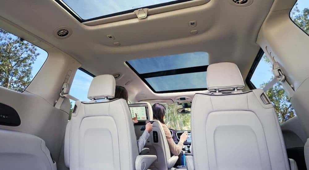 A view of the interior of a 2020 Chrysler Pacifica is shown from the cargo area.