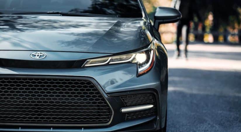 A closeup shows the grille of a gray 2020 Toyota Corolla.