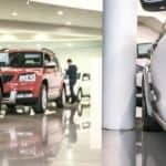 A showroom is shown that has cheap used cars for sale.