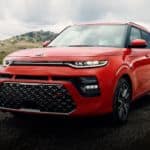 A red 2020 Kia Soul is parked on an empty race track.