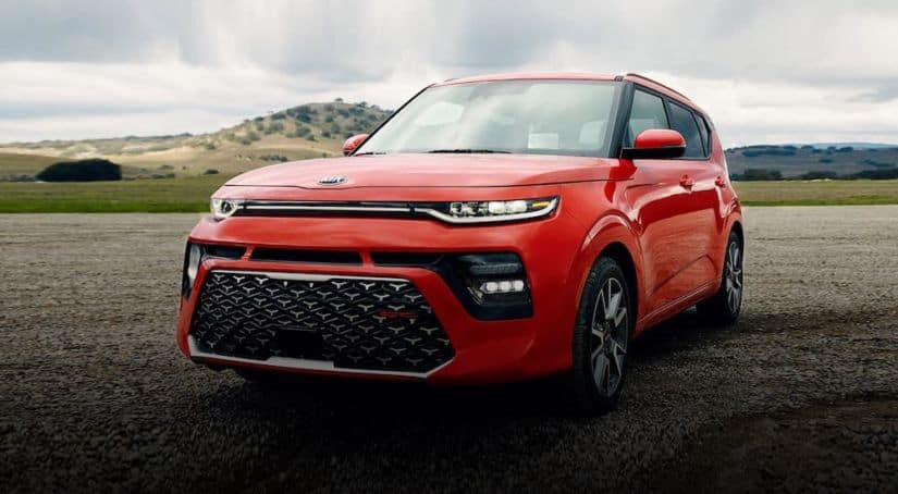 A red 2020 Kia Soul is parked on an empty race track.