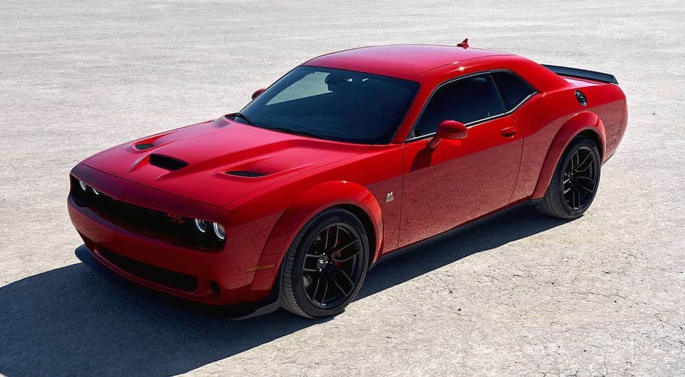 A red 2019 Dodge Challenger, a popular used car, is shown from an above angle on pavement.