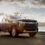 A black 2020 Chevy Silverado 2500HD High Country is parked in front of a river after winning the 2020 Chevy Silverado 2500HD vs 2020 Chevy Silverado 1500 comparison.
