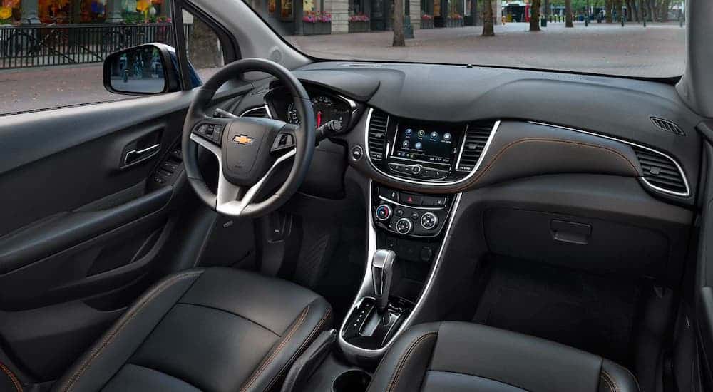 The black front seats and dashboard in a 2020 Chevy Trax are shown.