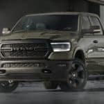 A green 2020 Ram 1500 is parked in a warehouse after winning the 2020 Ram 1500 vs 2020 Chevy Silverado 1500 comparison.