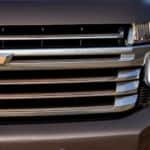 The grille of a grey 2021 Chevy Tahoe High Country is shown in closeup.