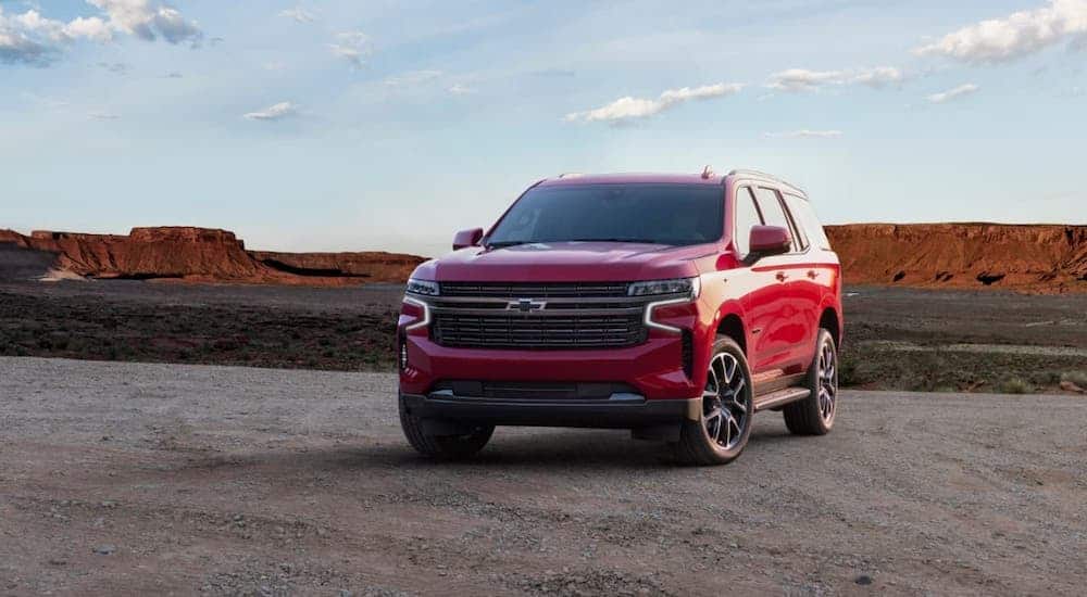 A red 2021 Chevy Tahoe RST is parked in front of a canyon.